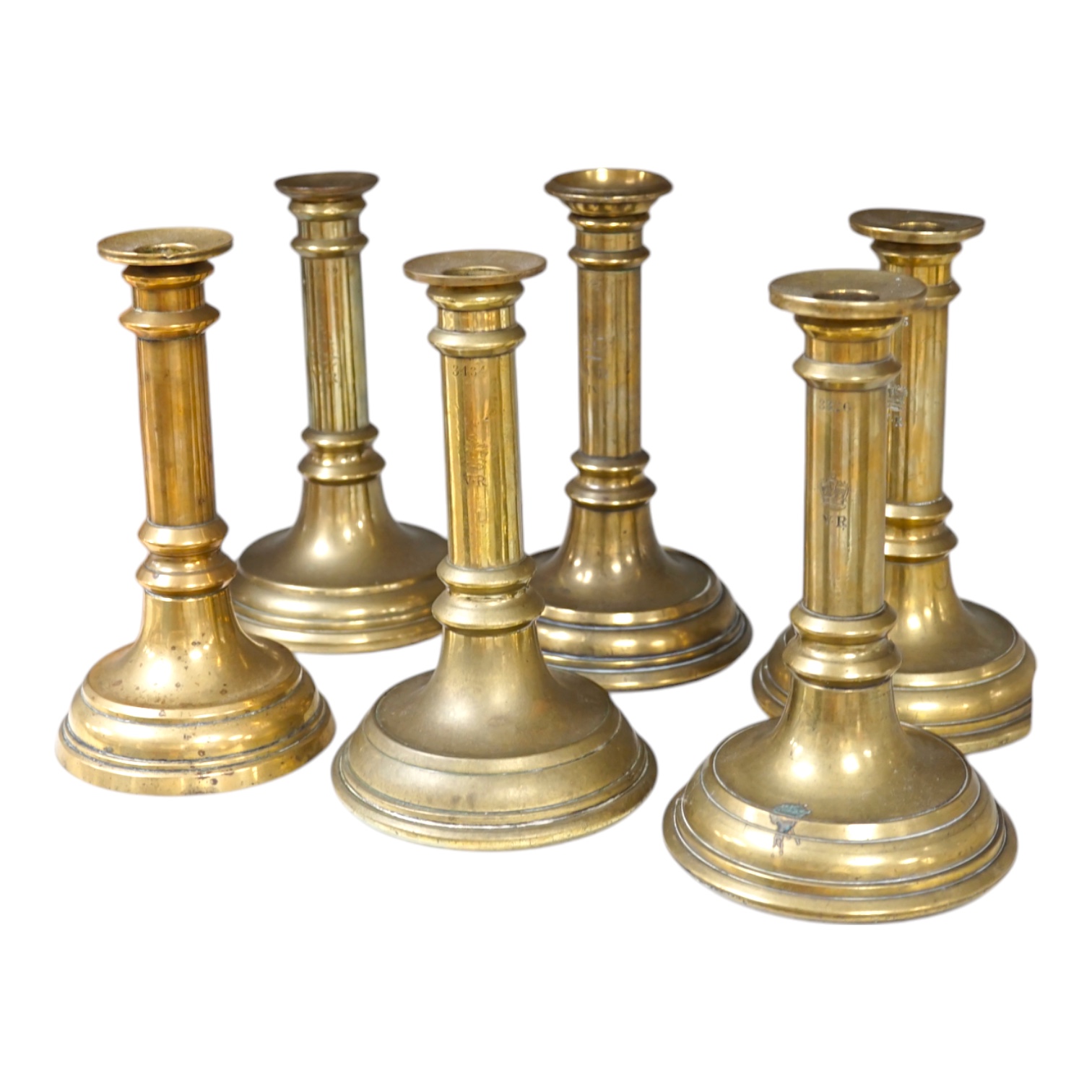 Six Victorian/William IV government issue brass candlesticks, five engraved with cipher crown and number 21.5cm high. Condition - fair.